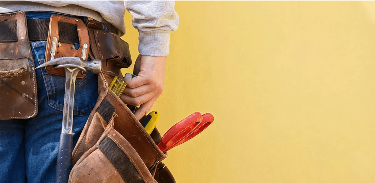 Handyman with tool belt ready for home repairs and maintenance in Savannah, GA