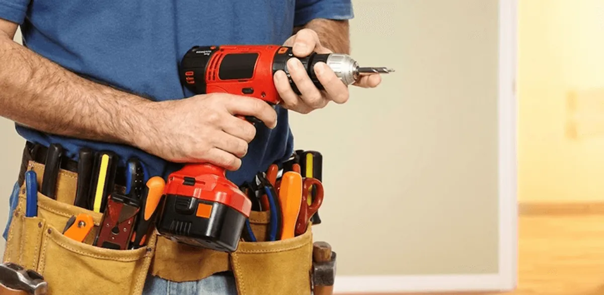 Handyman holding a power drill for home repairs and installations in Savannah, GA